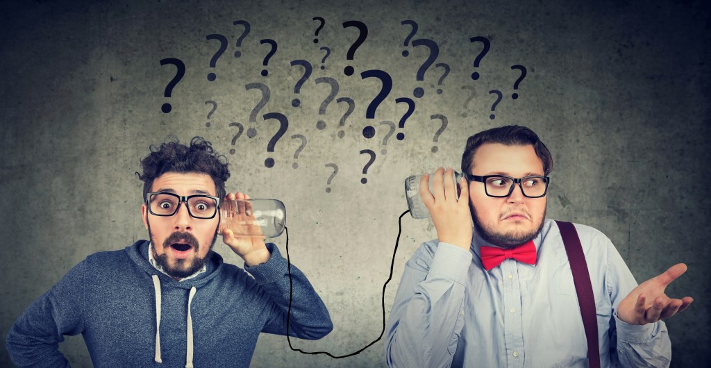 Two funny looking men having troubled communication.