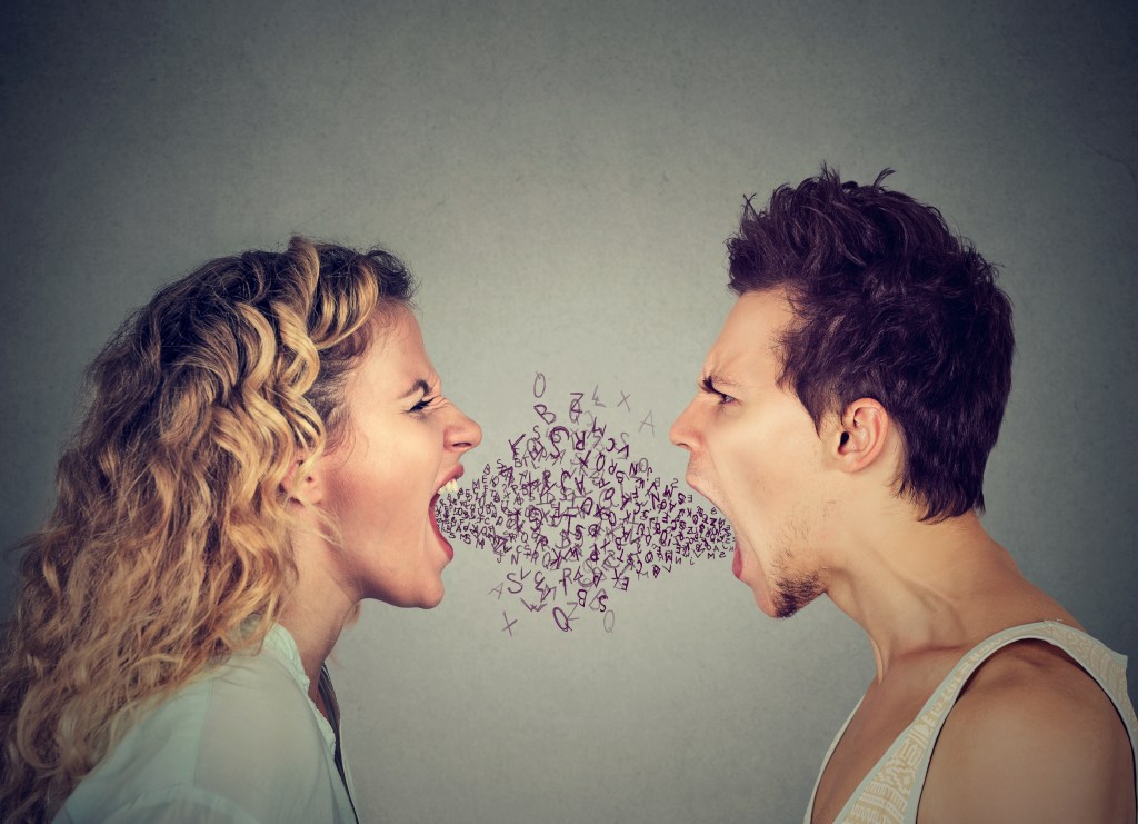 Angry man and woman screaming face to face with alphabet letters coming out of open mouth.