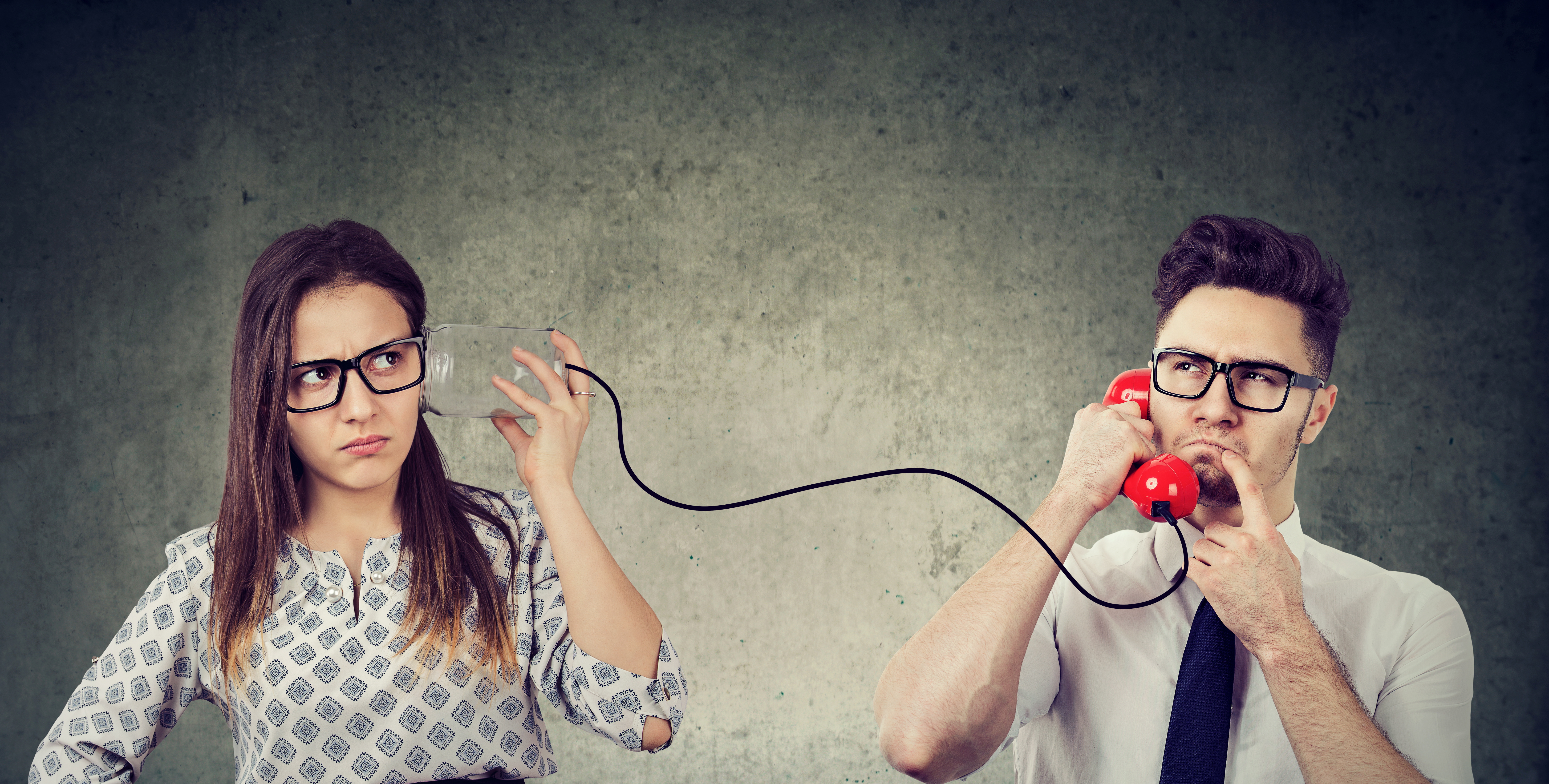 Portrait of a worried young woman listening to a man phone conversation..